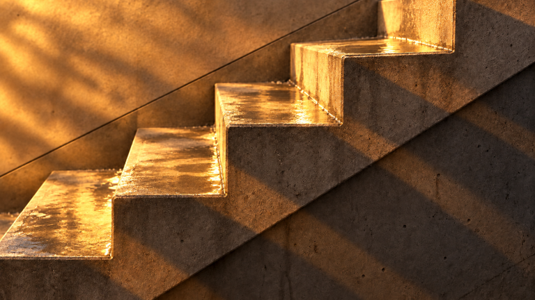 Concrete detail, after “Rain puddles reflecting the warm light on the concrete”